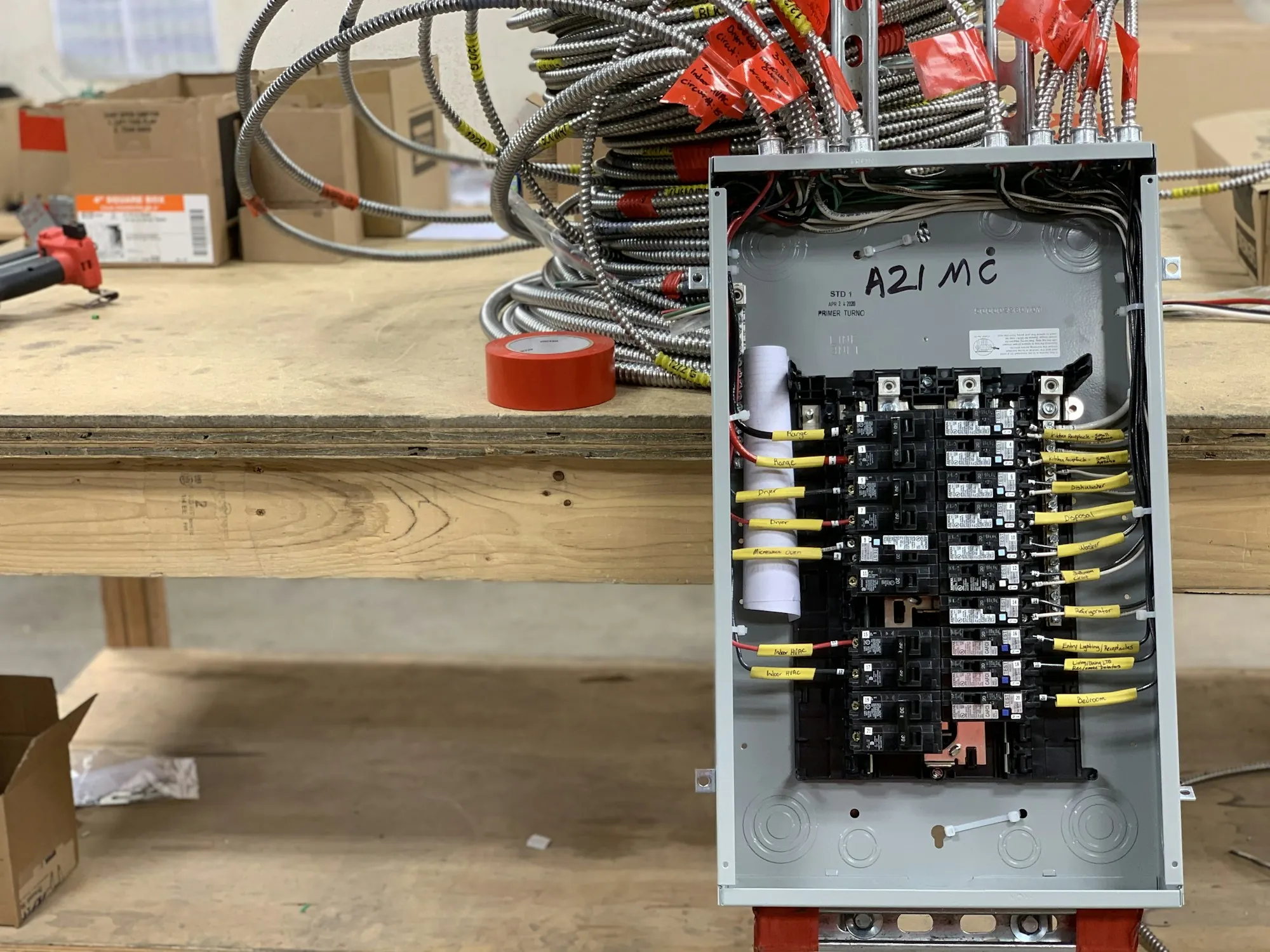 Residential breaker panel with neatly terminated wiring on a workbench